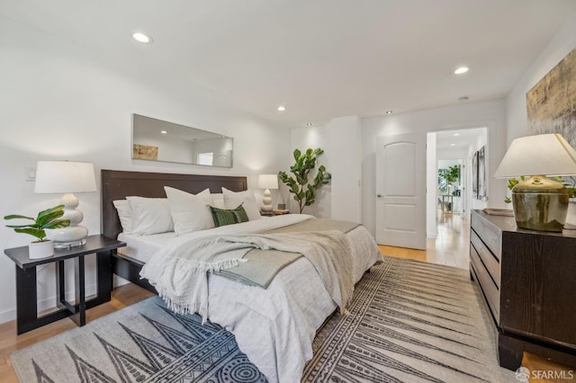 bedroom featuring light wood finished floors and recessed lighting