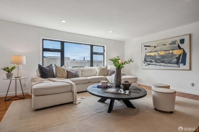 living area with recessed lighting, wood finished floors, and baseboards