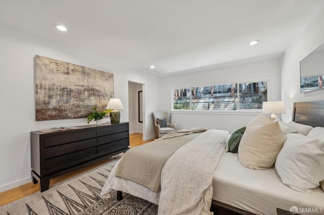bedroom featuring recessed lighting, light wood-style floors, and baseboards