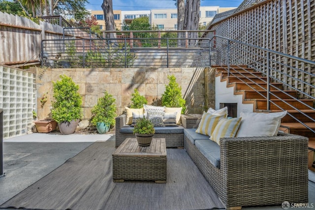 exterior space featuring a patio, stairs, and an outdoor hangout area