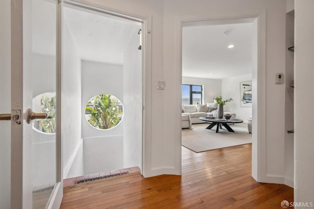 foyer entrance with visible vents and wood-type flooring