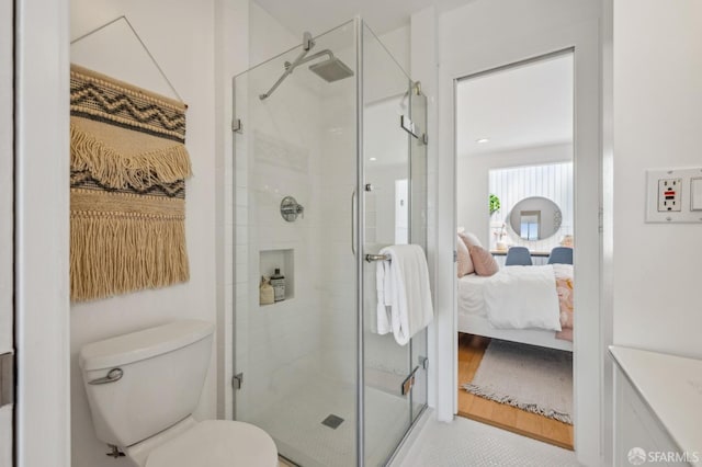 full bath with toilet, ensuite bathroom, and a stall shower