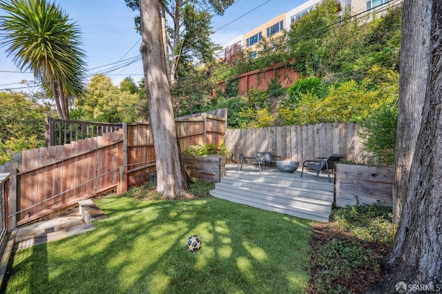 view of yard featuring fence and a wooden deck
