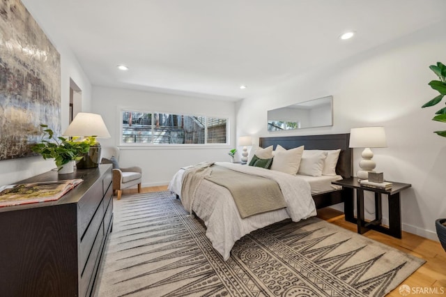 bedroom featuring light wood-type flooring, baseboards, and recessed lighting