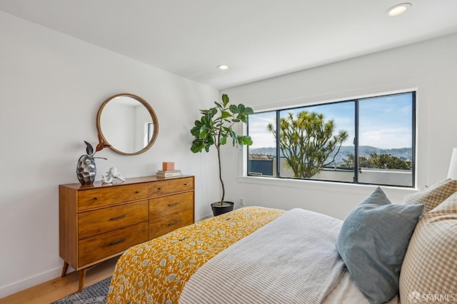 bedroom featuring baseboards, recessed lighting, and light wood-type flooring