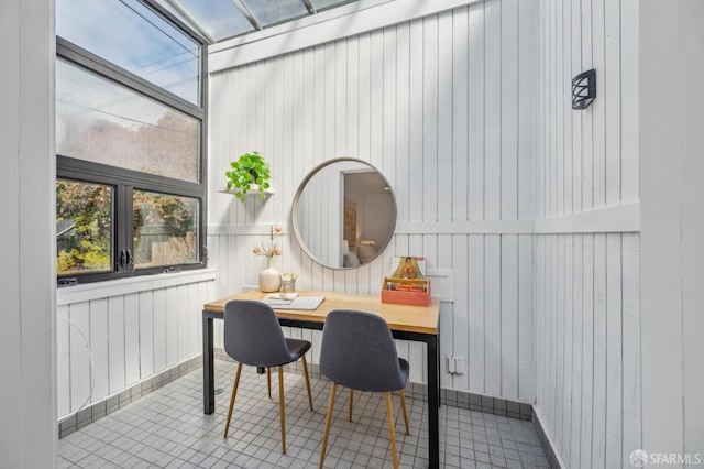 dining space with wooden walls