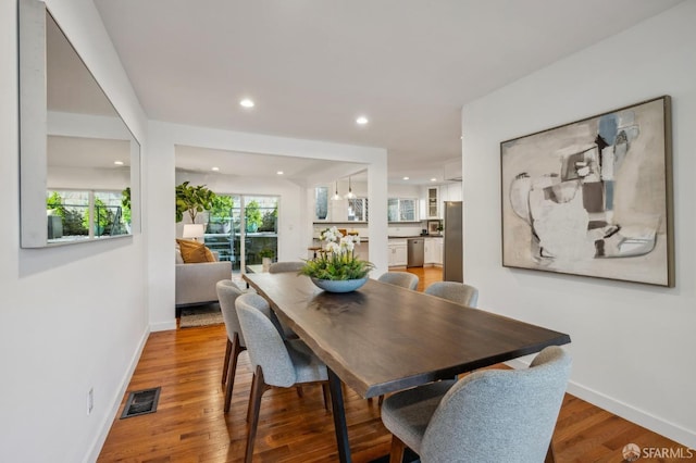 dining space with recessed lighting, light wood-type flooring, visible vents, and baseboards