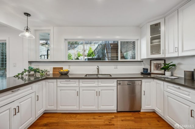 kitchen featuring a sink, dark countertops, white cabinetry, glass insert cabinets, and dishwasher
