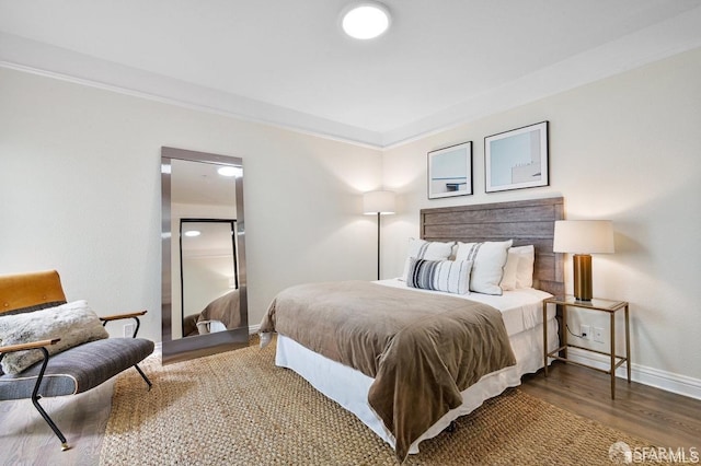 bedroom featuring hardwood / wood-style flooring and ornamental molding