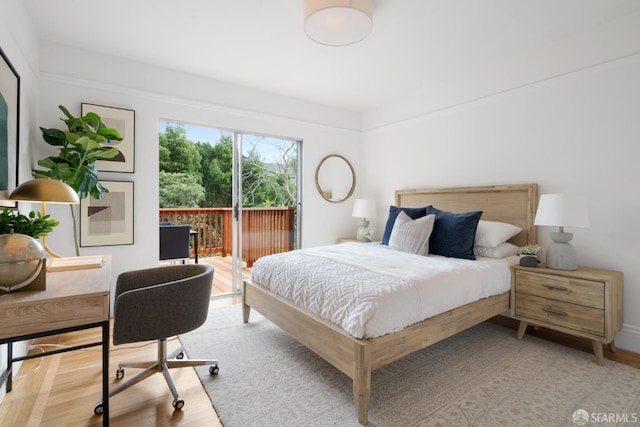 bedroom with access to outside and light wood-type flooring