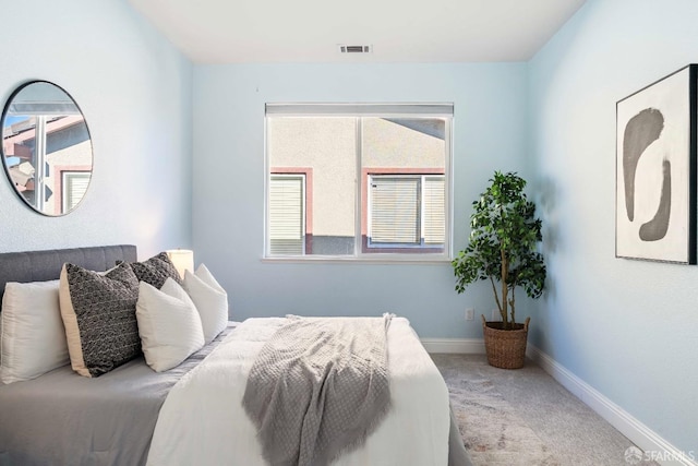 bedroom featuring multiple windows and carpet floors