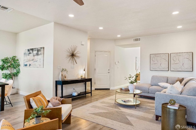 living room featuring ceiling fan and light hardwood / wood-style floors