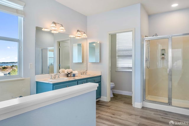 bathroom with a shower with door, wood-type flooring, and toilet