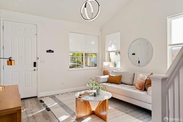 living room featuring vaulted ceiling and light hardwood / wood-style floors