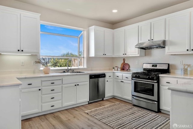 kitchen featuring white cabinetry, appliances with stainless steel finishes, light hardwood / wood-style floors, and sink