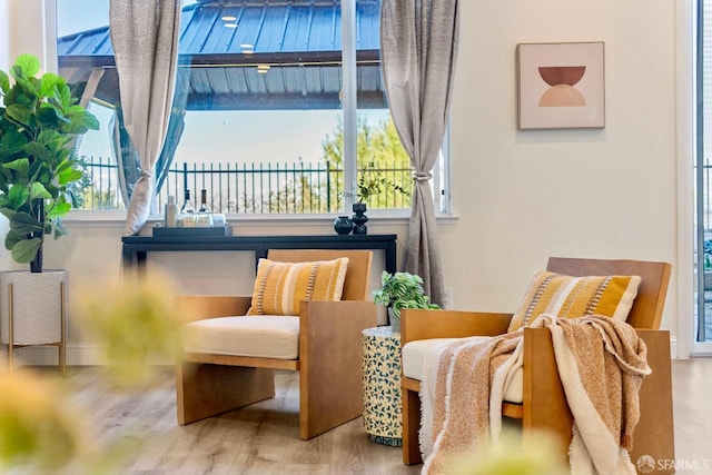 living area featuring a water view and hardwood / wood-style floors