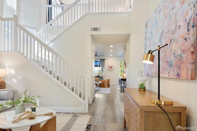 entryway with a towering ceiling and light hardwood / wood-style floors