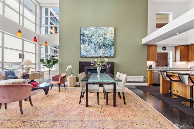 33 Clementina St Unit 3, San Francisco, CA 94105 - dining area featuring a high ceiling, dark wood finished floors, baseboards, and a fireplace