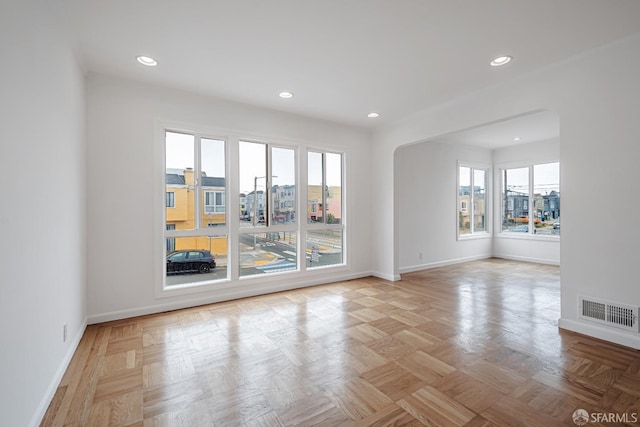 spare room featuring recessed lighting, baseboards, visible vents, and a wealth of natural light