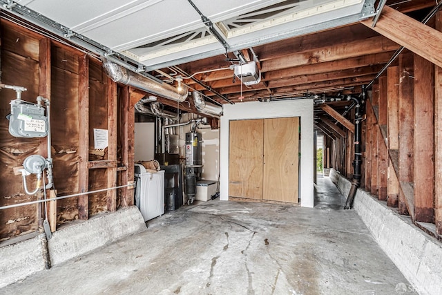 garage featuring secured water heater, a garage door opener, and washer and clothes dryer