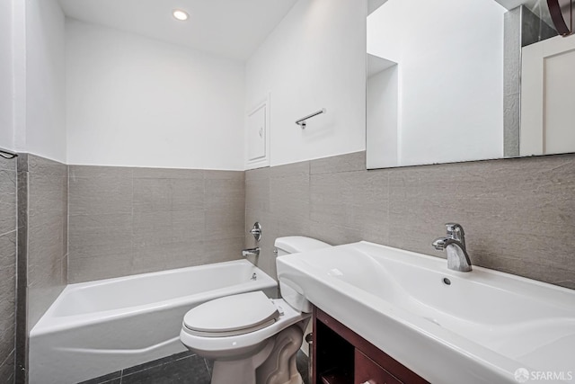 bathroom featuring a bath, vanity, tile walls, toilet, and recessed lighting