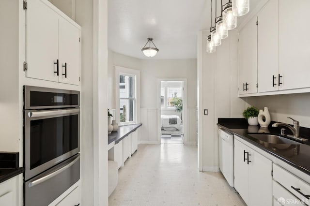 773 15th Ave, San Francisco, CA 94118 - kitchen featuring a warming drawer, dishwasher, oven, dark countertops, and white cabinets
