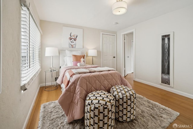 773 15th Ave, San Francisco, CA 94118 - bedroom with baseboards, wood finished floors, and a heating unit