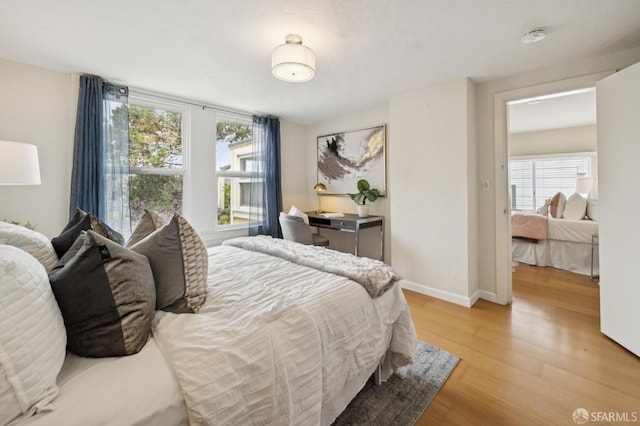 773 15th Ave, San Francisco, CA 94118 - bedroom with light wood-type flooring, multiple windows, and baseboards
