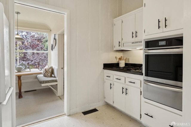 773 15th Ave, San Francisco, CA 94118 - kitchen with stainless steel oven, a warming drawer, ventilation hood, gas stovetop, and white cabinetry