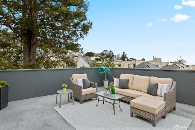 view of patio featuring an outdoor hangout area and a balcony