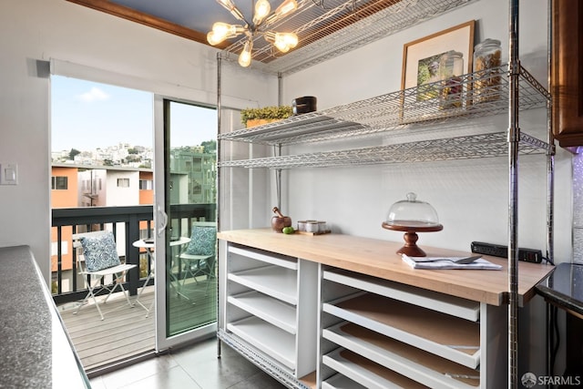 interior space with tile patterned floors and an inviting chandelier