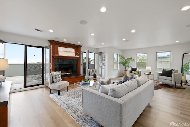 living room featuring light hardwood / wood-style floors and a fireplace