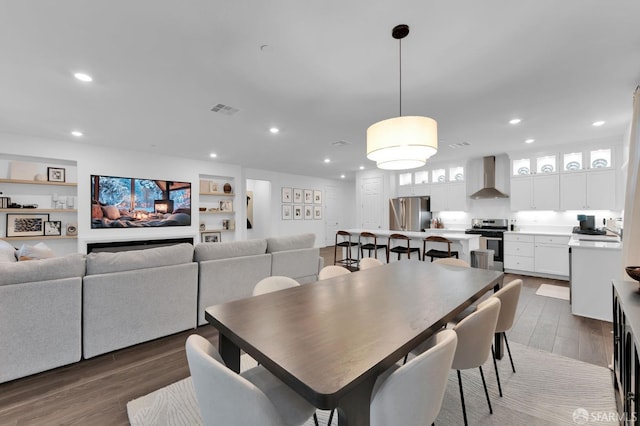 dining area featuring dark hardwood / wood-style flooring and built in features