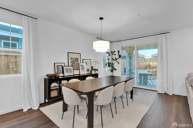 dining room with a healthy amount of sunlight and dark hardwood / wood-style floors