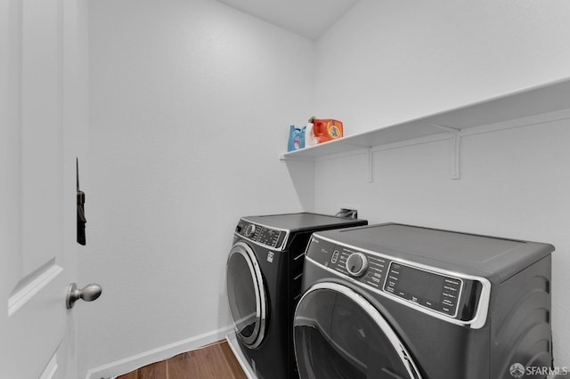 laundry area featuring dark hardwood / wood-style flooring and washer and clothes dryer