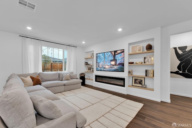 living room featuring hardwood / wood-style flooring and built in features