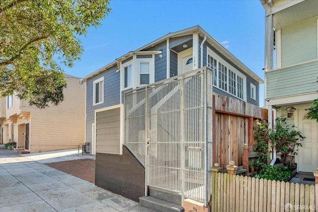 view of front facade with fence and a gate