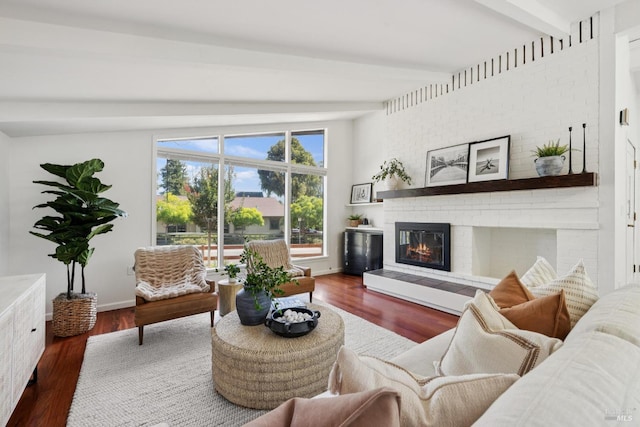 703 W St, Petaluma, CA 94952 - living area with beamed ceiling, a brick fireplace, and wood finished floors