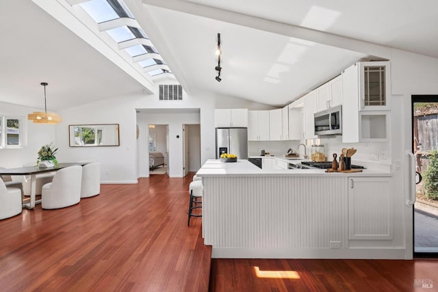 703 W St, Petaluma, CA 94952 - kitchen with appliances with stainless steel finishes, a peninsula, light countertops, and dark wood finished floors