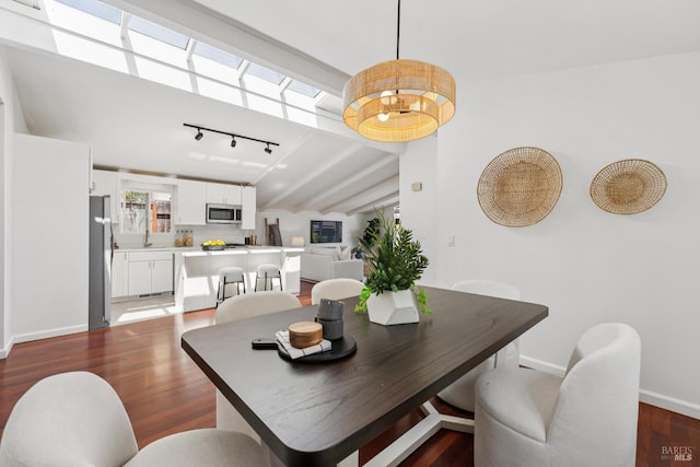 703 W St, Petaluma, CA 94952 - dining area featuring wood finished floors, vaulted ceiling, and track lighting