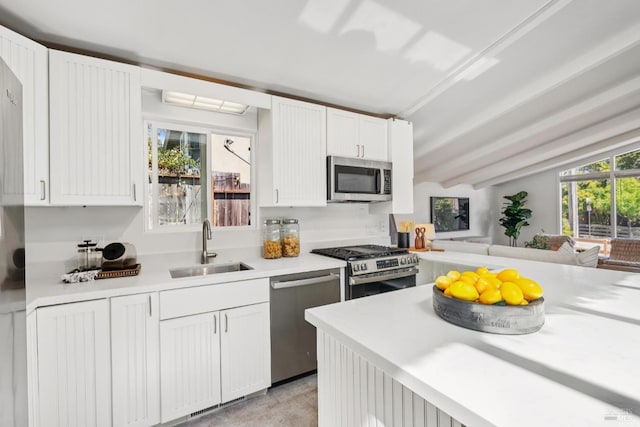 703 W St, Petaluma, CA 94952 - kitchen with stainless steel appliances, light countertops, white cabinetry, and open floor plan