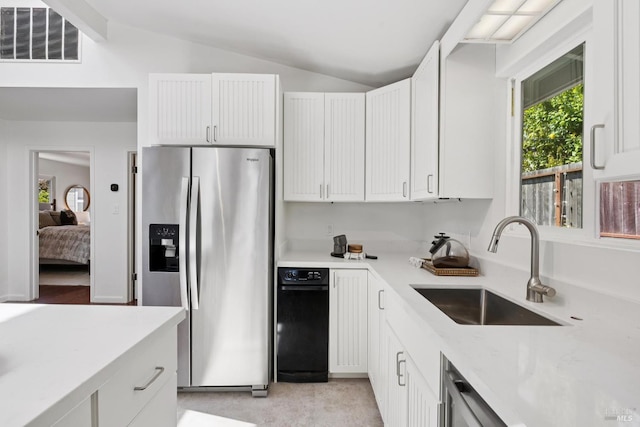 703 W St, Petaluma, CA 94952 - kitchen featuring stainless steel fridge with ice dispenser, vaulted ceiling, white cabinetry, and light stone counters
