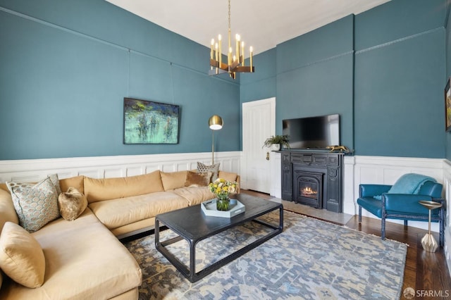 living room featuring a notable chandelier and dark hardwood / wood-style floors