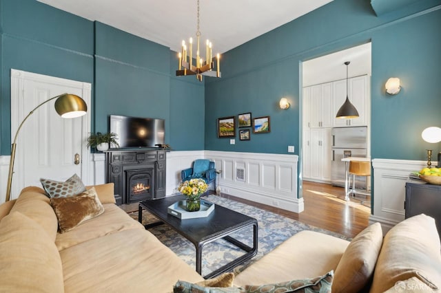 living room featuring an inviting chandelier and wood-type flooring