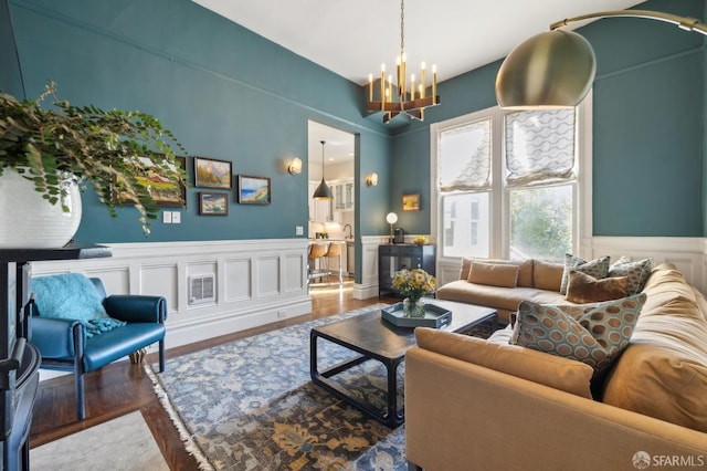 living room with hardwood / wood-style floors and a chandelier