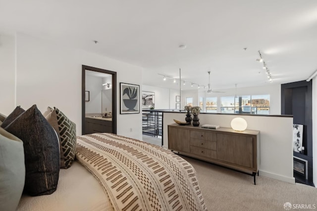 bedroom with light carpet and connected bathroom