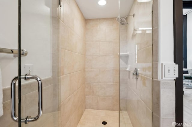 bathroom featuring a shower with door