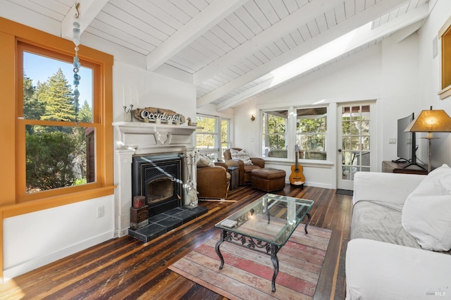 living area featuring a fireplace with raised hearth, hardwood / wood-style flooring, baseboards, and vaulted ceiling with beams