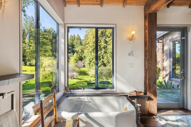 sunroom featuring beam ceiling