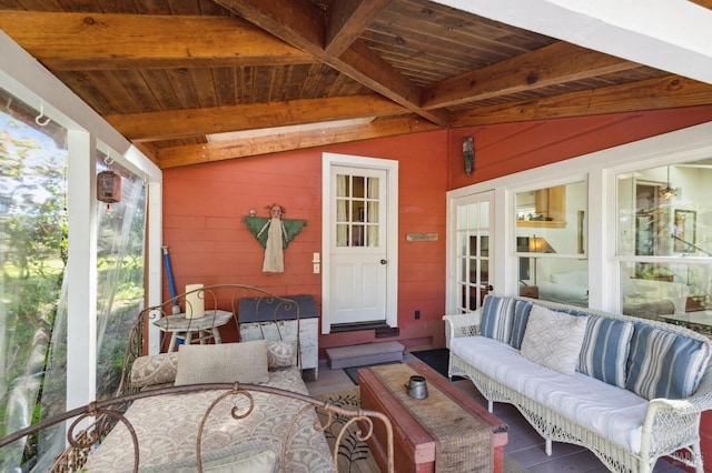 sunroom featuring an outdoor hangout area and beam ceiling